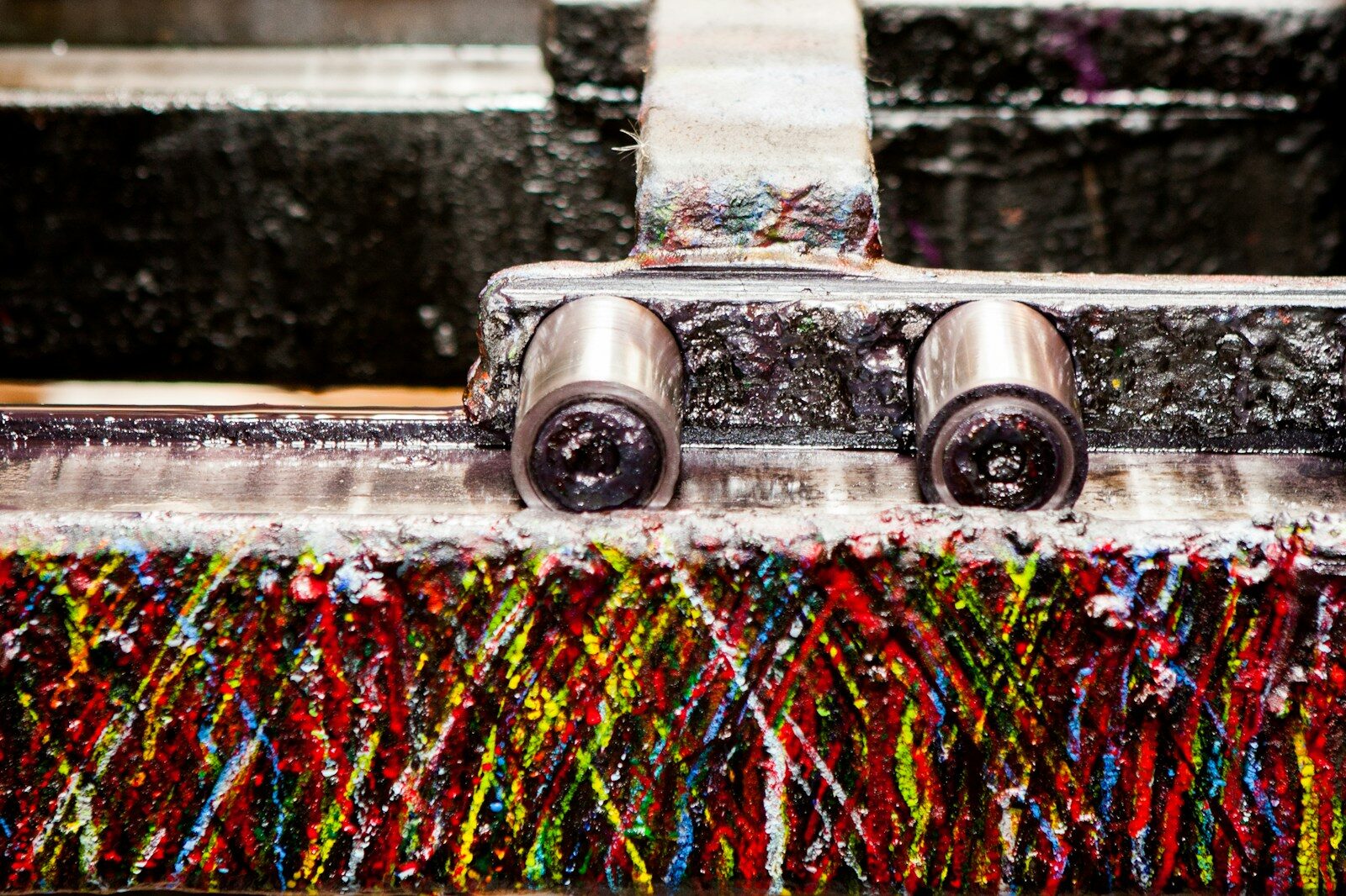 a close up of a metal object with a lot of paint on it