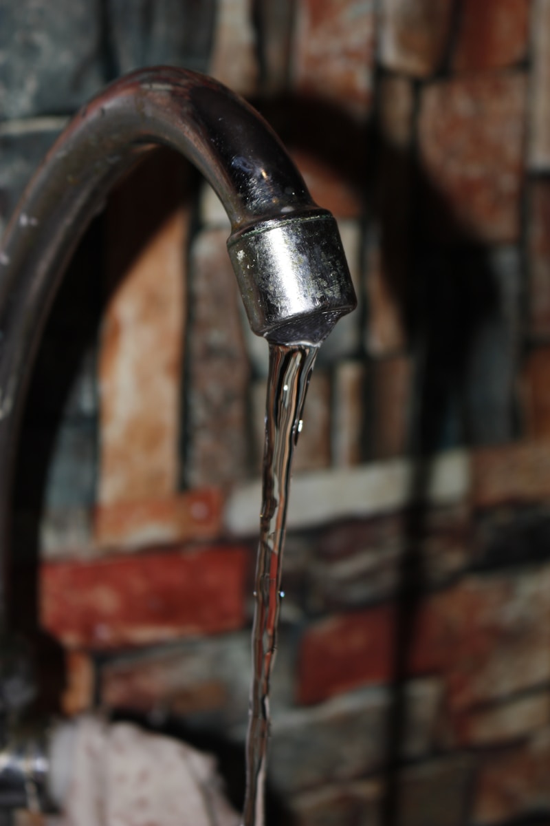 a close up of a faucet with water coming out of it