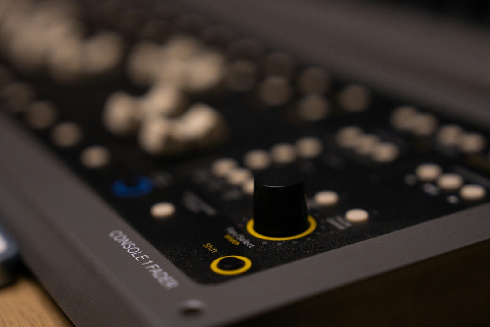 Close-up of a mixing console with a knob